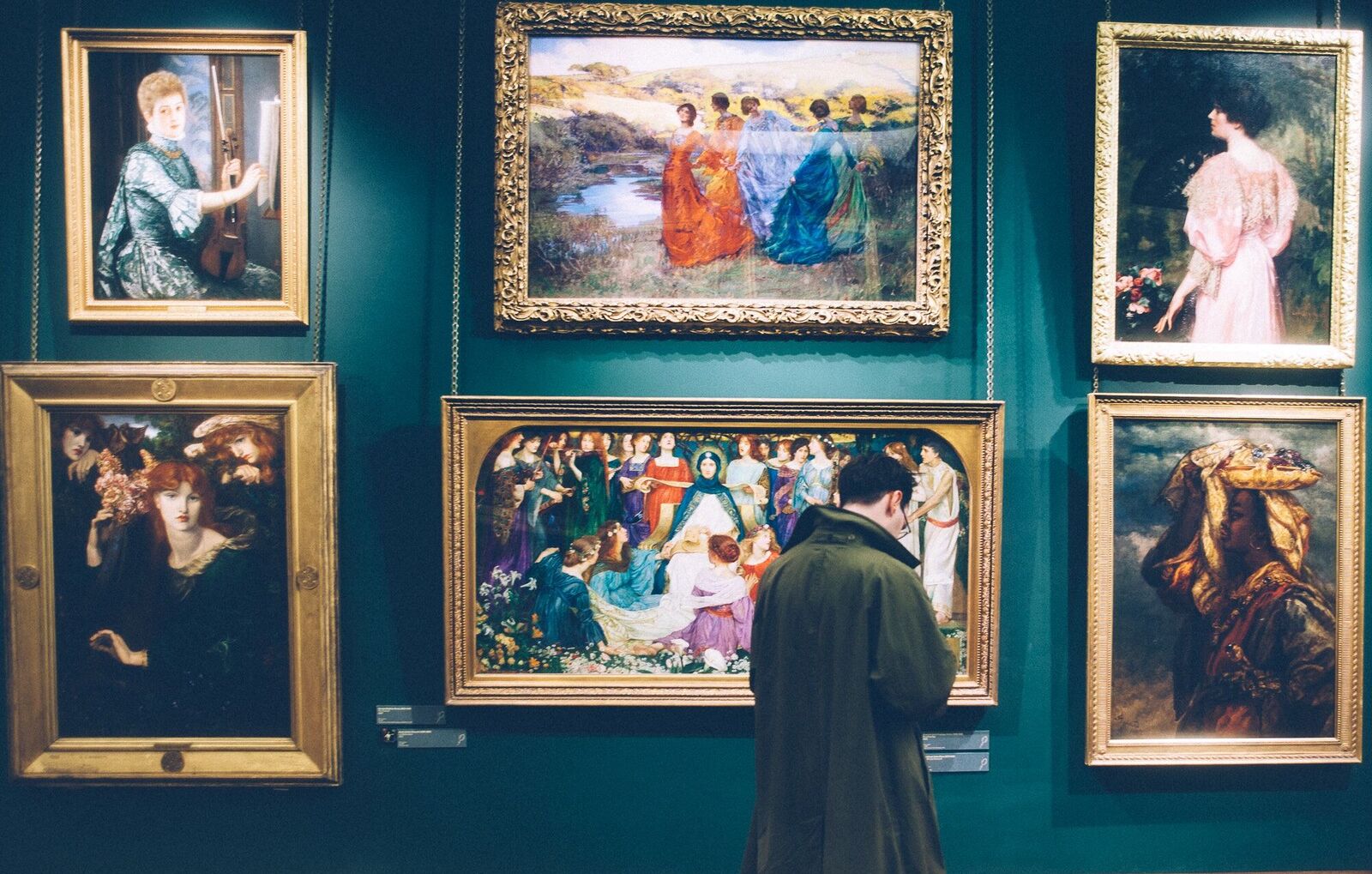 Man looking at paintings